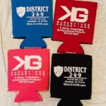 Four different colored koozies with the words district 2 4 9 and pg promotions.
